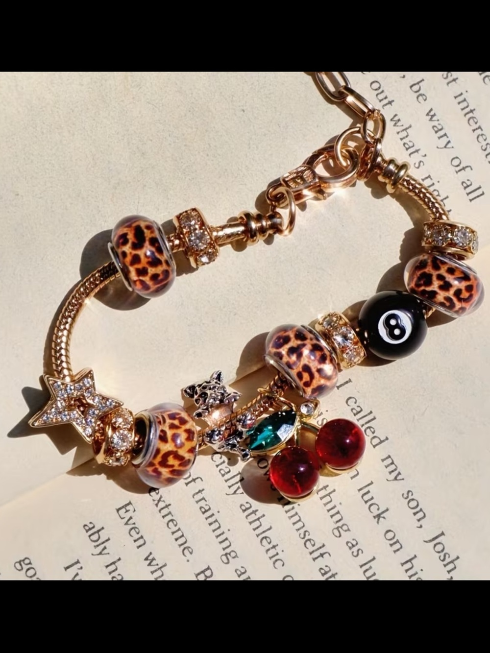 Gold-Tone Leopard Bead Charm Bracelet with Red Cherry and Eight Ball Charms